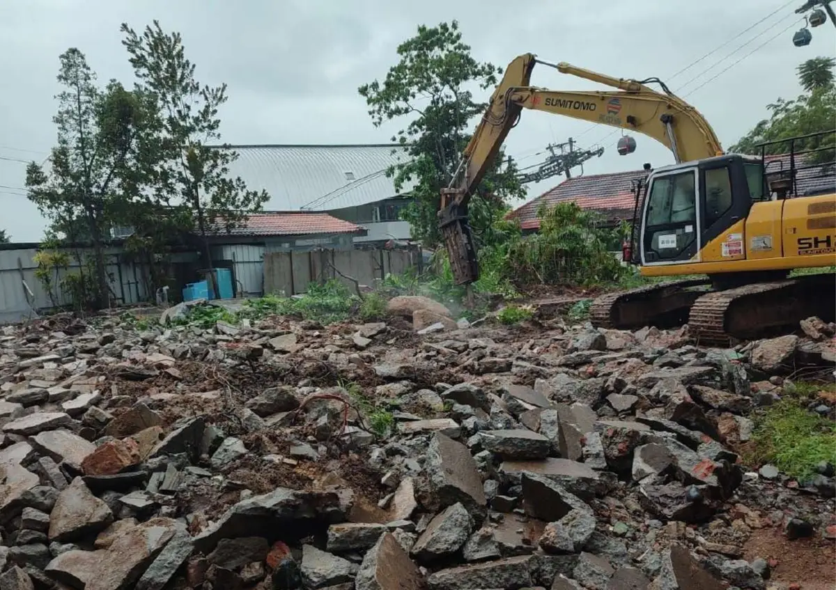 Excavator clearing a demolition site