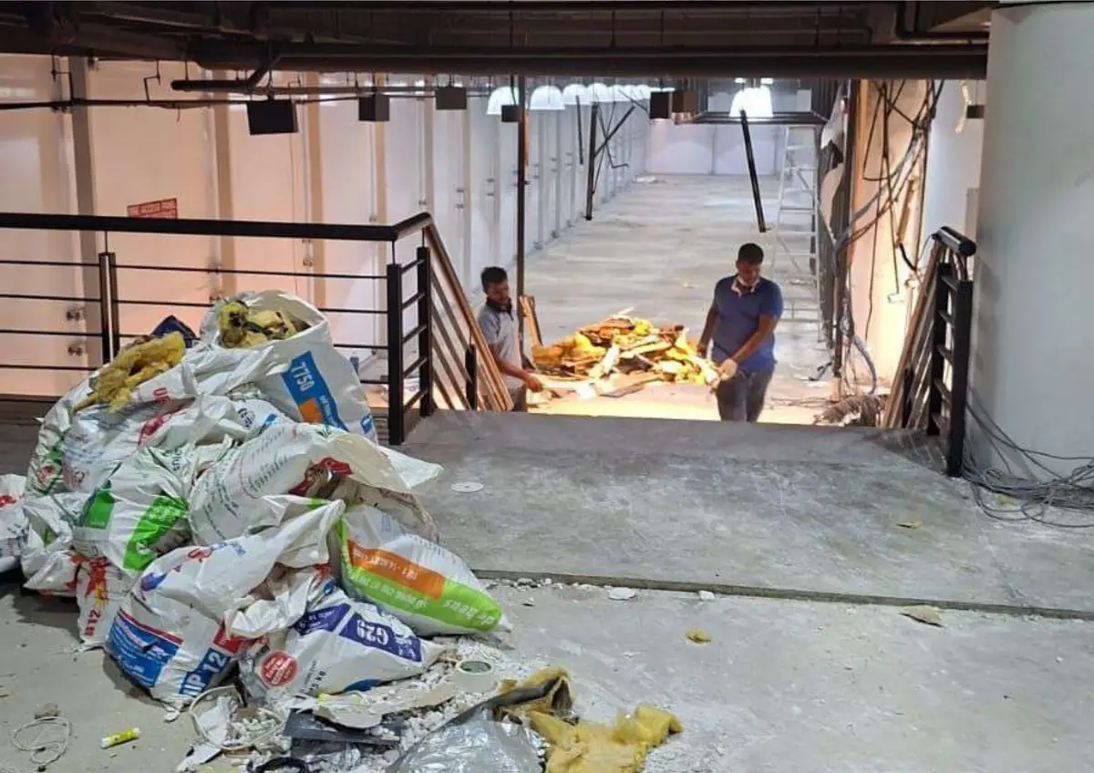 Debris bagged for disposal in a mall unit