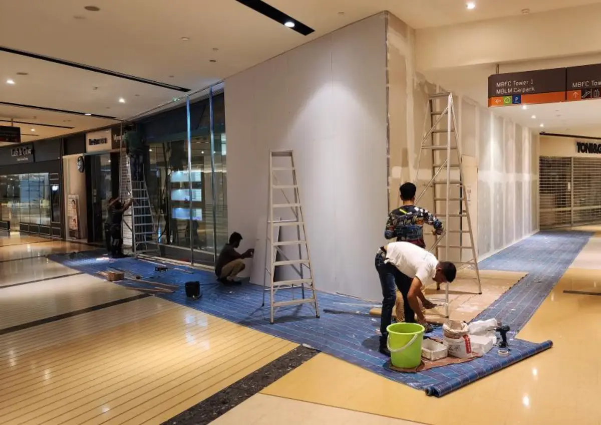 Contractors working on a hoarding installation